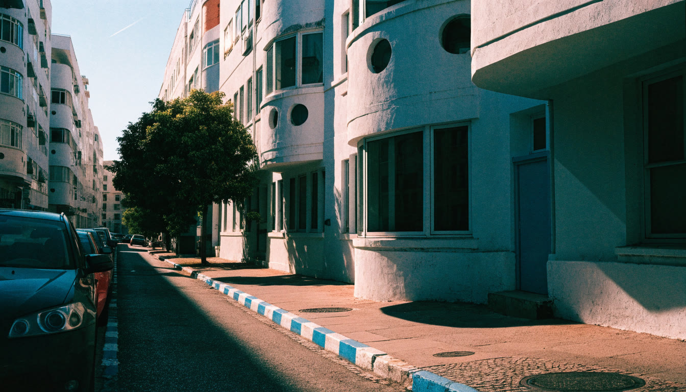 Illustration: a residential street lined with parked cars beside a blue-and-white painted kerb